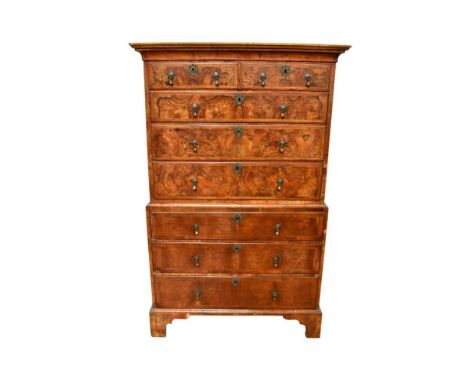 Early 18th century figured walnut chest on chest, with concave cornice and two short over six long graduated drawers on brack