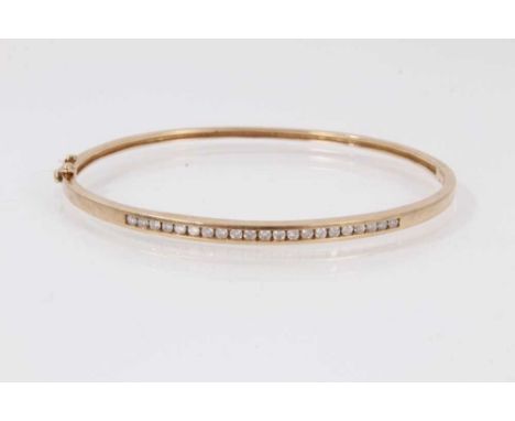 Diamond bangle with channel set brilliant cut diamonds in 9ct gold setting.6.9 grams. The internal diameter is approximately 