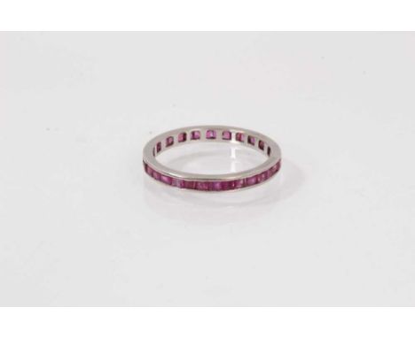 Ruby eternity ring with a full band of calibre cut rubies in channel setting, ring size Q½.