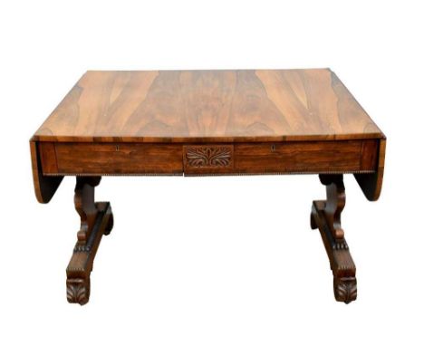 Good George IV rosewood library table, with drop leaf top of two drawers to the tablet frieze on acanthus carved standard end