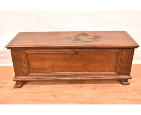 Early 18th century Italian cedar cassone, with expansive hinged top and panelled front between decorative stiles, on bracket 