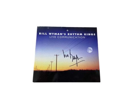 A copy of The Rolling Stones' Bill Wyman's Rhythm Kings: Live Communication CD, bearing the signature of Wyman in black ink.