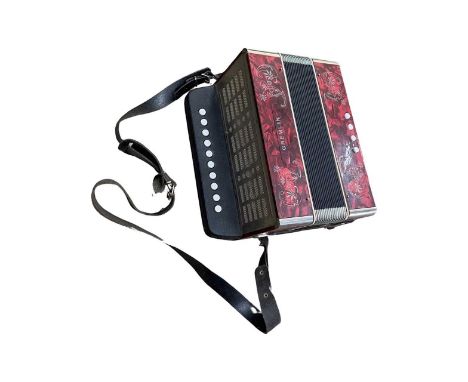A Gremlin accordion with etched floral details on a marbled deep red background