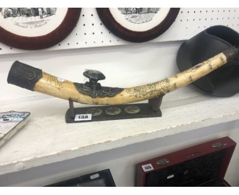 An etched bone and metal pipe