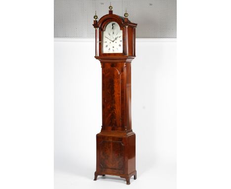 A 19th century flame mahogany eight-day longcase clock. With arched hood and three finials, the silvered dial inscribed WILLI