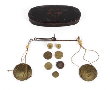 A set of George III travelling pocket scales in black and gilt oval metal case. The various weights marked GRIII, DwGr 5:8, 2