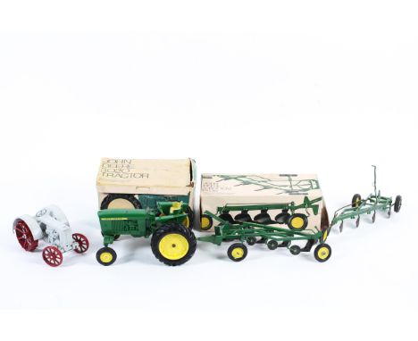 Three Ertl 1:16 scale diecast models. Comprising a John Deere 3020 Tractor and John Deere 4-Bottom Plow, both in the original