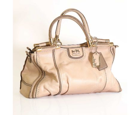 A Coach beige handbag,  with dual rolled handles, gold tone hardware, zip closure with interior zip and slip pockets, with du
