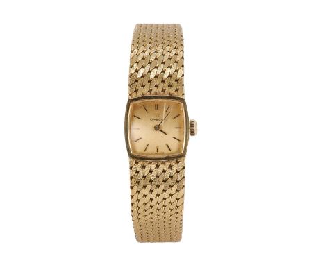 A ladies' 18ct gold Omega mechanical bracelet watch, with a plain cushion shaped case, 15mm x 15mm, a gilt dial, black baton 