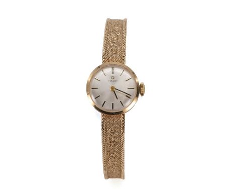 A ladies' 9ct gold Tissot mechanical bracelet watch, 17mm diameter, with a silvered dial, gilt baton hour markers, blued bato