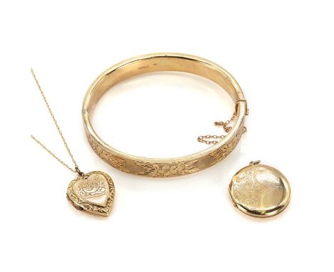 A 9ct gold bangle and two back and front lockets, a 9ct gold hollow hand engraved bangle, oval in shape with floral hand engr