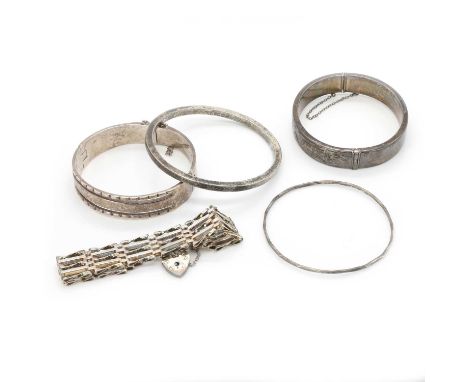 A group of silver bangles and a silver gate bracelet, comprising: a silver five row gate bracelet, 185mm long, London 1979, a
