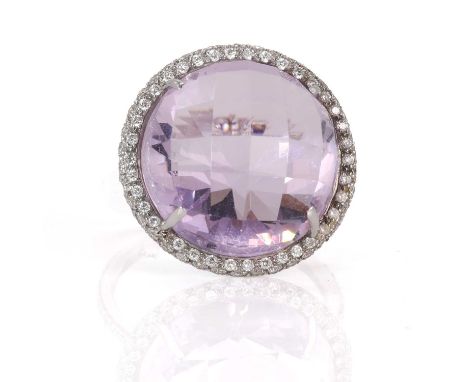 An amethyst and diamond halo cluster ring, by Giovane of New York, a circular checker cut amethyst with a stated weight of 14