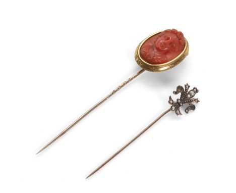 An antique coral cameo stick pin and a seed pearl stick pin, the deep red coral cameo depicting the bust of a woman, perhaps 