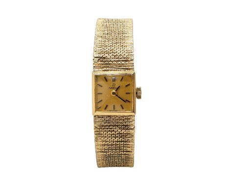 A 9ct gold ladies' Omega mechanical bracelet watch, ref.1061, 14mm x 14mm case, with a gilt dial, gilt batons and hands, 17 j