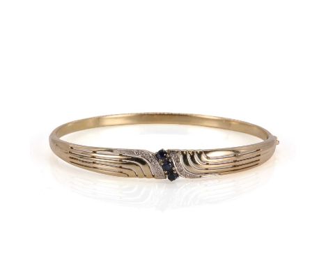 A gold sapphire and diamond hinged bangle, with three round cut sapphires, claw set and flanked by eight cut diamonds faced i