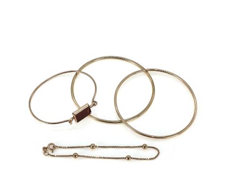 Three 9ct gold bangles and one 9ct gold bracelet, comprising:two 9ct gold round bangles,both with solid round wire, inner dia