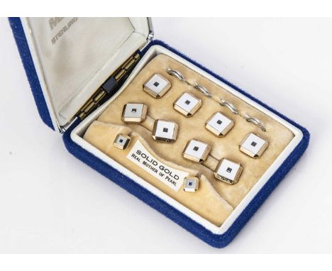 A 9ct gold and mother of pearl gentleman's dress stud set, the square fronts inset with blue centre stones, 12g
