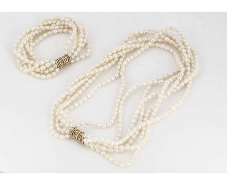A matching set of 18ct gold and freshwater pearl necklace and bracelet, the multi strand united by a two colour linked clasp,