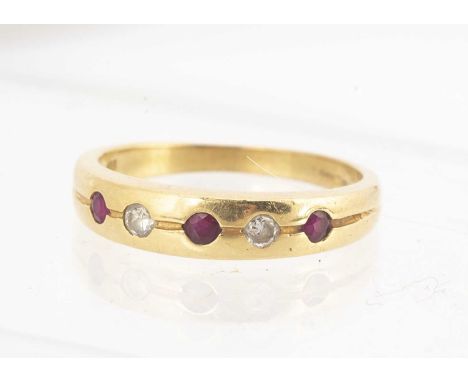 An 18ct gold ruby and diamond dress ring, the round cut stones alternately set in sunken settings, ring size O, 3.7g