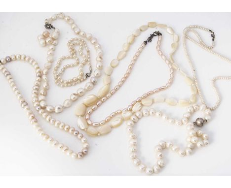 A collection of freshwater and salt water cultured pearl necklaces, including a mother of pearl example