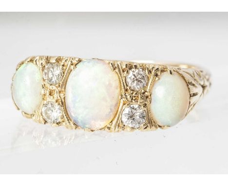 An 18ct gold precious white opal and diamond ring, oval cabochon opals in four claw settings, alternately set with pairs of b