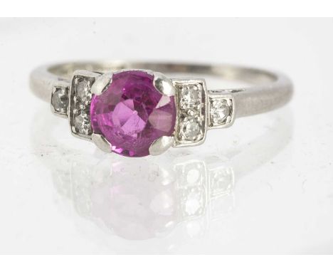 An Art Deco platinum diamond and synthetic ruby dress ring, the round cut stone, claw set, with eight cut diamond set shoulde
