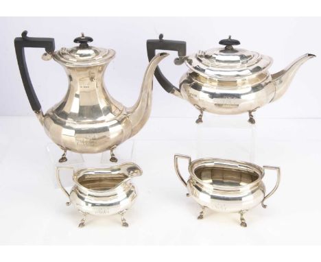 A George V silver four piece tea and coffee set by JS, including teapot, coffee pot with silver and muslin insert, sugar basi