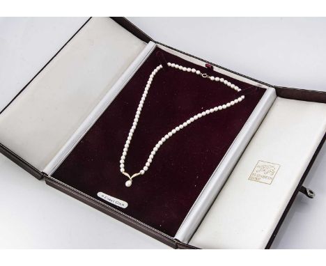 A cultured uniform pearl necklace and pendant,  with 9ct gold mounts, cased