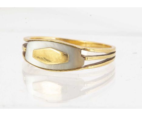 A late 19th Century mother of pearl and gold signet ring, the curved carved panel inset with a rhombus shaped cartouche on a 