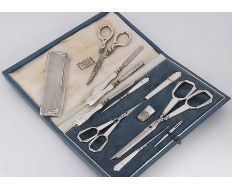 A nice Art Deco period French silver cased sewing set retailed through Harrods, with two pairs of silver handled scissors, 16