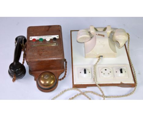 IVORY COLOURED PLASTIC SHIP'S ON-BOARD TELEPHONE, mounted on an oblong panel for wall mounting, electric socket and two switc