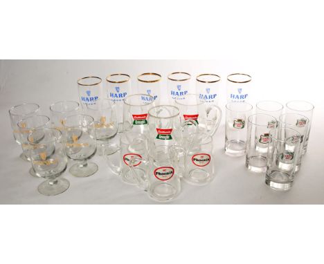 A collection of 1970s and 1980s pub glassware to include 6 Guinness half pint glasses, 6  Harp half pint glasses, 3 Smithwick