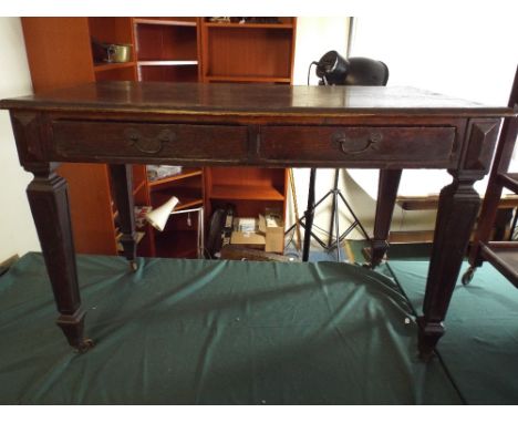 An Edwardian Oak Two Drawer Side Table on Square Tapering Legs with Spade Feet and Castors. 