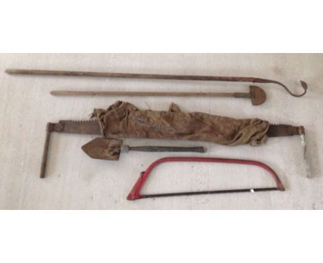 A collection of old tools to include a 2 handed saw.