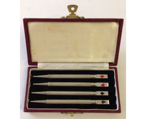 A set of 4 Sterling silver bridge pencils with enamel playing card suit decoration in the original fitted box.