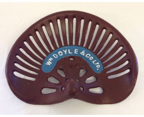 A painted cast iron Wm. Doyle & Co. tractor seat