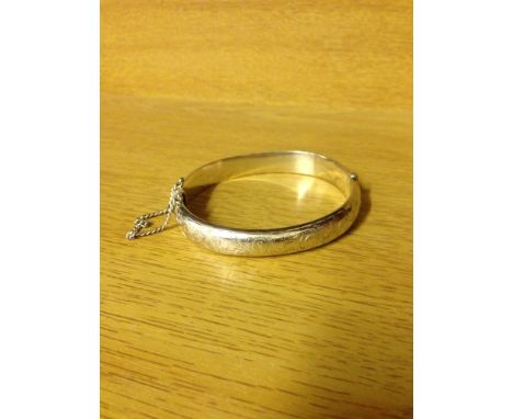 A HM silver bangle with safety chain - Birmingham 1965, maker S.P.S & Co., approx 16.8g.