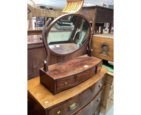 Nineteenth century mahogany bowfronted toilet mirror on base with oval plate, the base fitted with three drawers, on bracket 