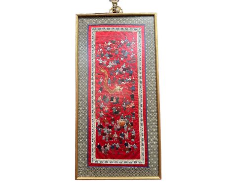 Chinese embroided silk panel depicting children playing, on vibrant red ground, in glazed gilt frame