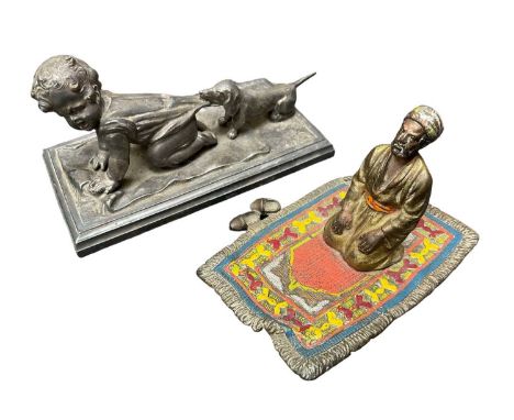 Cold painted bronze figure of an Arab, praying to Mecca, 8cm wide, and a silver plated sculpture
