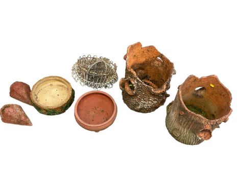 Two terracotta tree trunk planters and other garden items