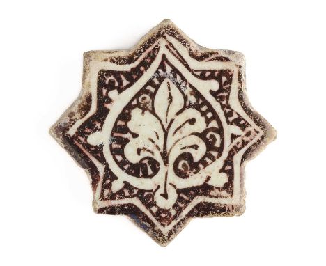 A SMALL KASHAN LUSTRE STAR TILE, PERSIA, 13TH CENTURY  fritware, painted with a palmette motif, enclosed within a bud form on