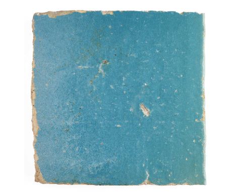 A KASHAN TURQUOISE MONOCHROME TILE, PERSIA, 13TH/14TH CENTURY  glazed fritware, of square form, the face and one edge glazed,
