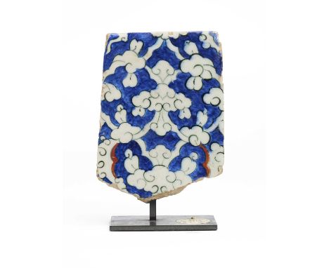 AN IZNIK TILE FRAGMENT, OTTOMAN ANATOLIA, 1560-70  underglaze painted fritware, with reserved white Chinese cloud trellis on 