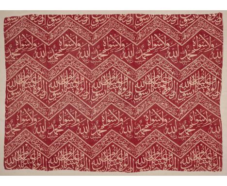 A SILK CALLIGRAPHIC TEXTILE, OTTOMAN, CIRCA 17TH CENTURY with white calligraphy on a red ground, unframed, 44 by 75cmThis is 