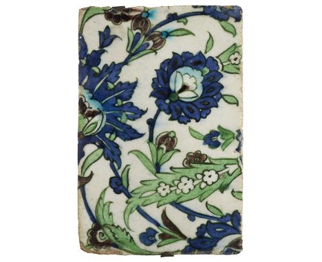 A DAMASCUS TILE FRAGMENT, OTTOMAN SYRIA, LATE 16TH CENTURY  underglaze painted fritware, with a design of scrolling floral te