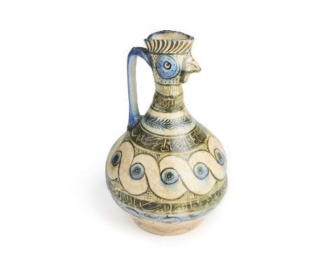 A KASHAN BLUE, BLACK AND WHITE GLAZED COCKEREL-HEAD POTTERY EWER, PERSIA, 13TH CENTURY  the bulbous body on ring foot, the ne