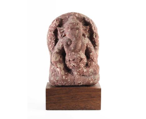A MOTTLED PINK SANDSTONE RELIEF DEPICTING GANESHA, NORTHERN INDIA, CIRCA 8TH CENTURY  seated in rajalilasana, with flared ear