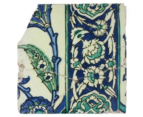 A FRAGMENTARY IZNIK TILE, OTTOMAN ANATOLIA, 17TH CENTURY underglaze painted fritware, decorated in copper and cobalt blue on 